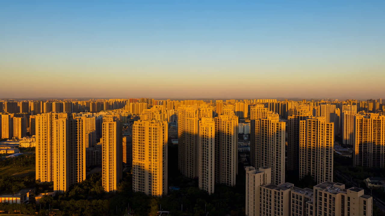 Sunset Highrise Skyline Bathed In Sunlight, Dense Curtain Of Apartment Towers Stretching To Horizon