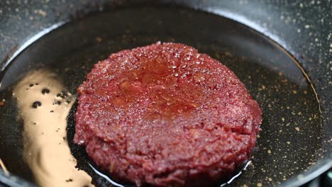 vegan burger frying in a pan