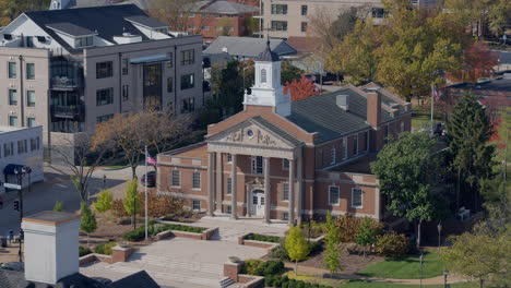 aerial push towards city hall building on a pretty autumn day in kirkwood, missouri