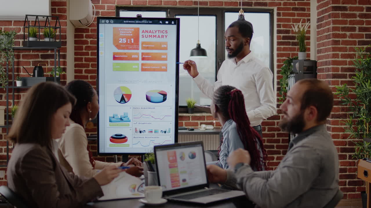 Employee doing marketing analysis on monitor at business meeting