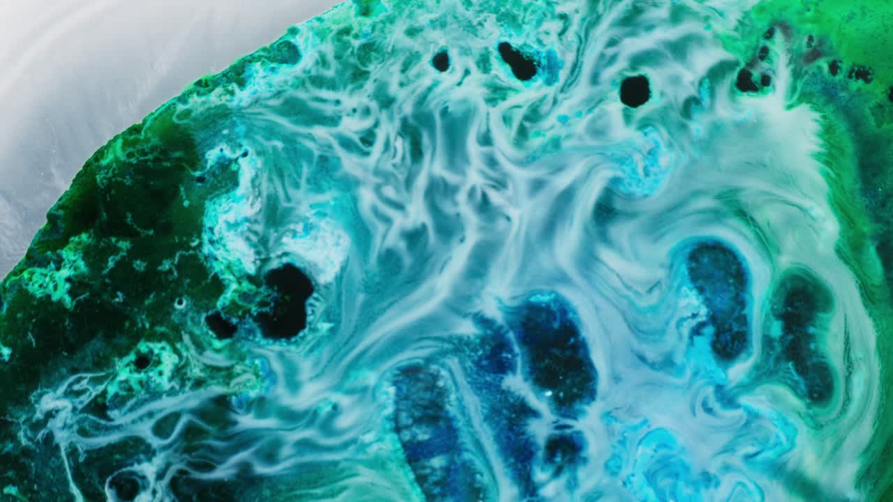 Colorful alcohol ink swirling in macro view, abstract motion with vibrant textures