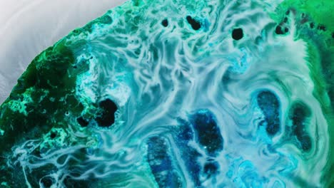 colorful alcohol ink swirling in macro view, abstract motion with vibrant textures
