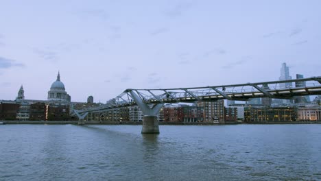 millennium bridge evening with st paul's in the background and people walking past