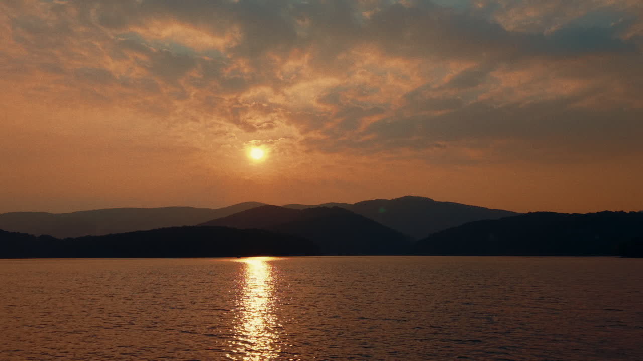 Sunset over a Lake with Mountains