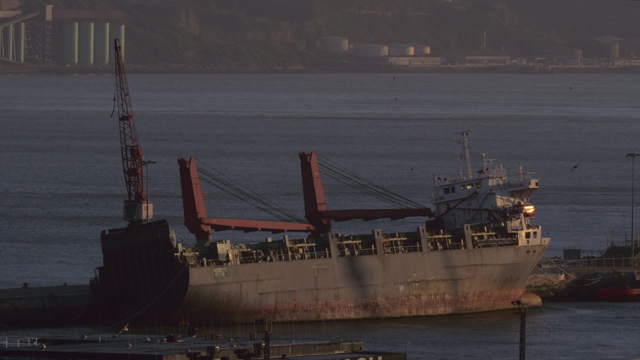 A peaceful landscape with an abandoned barge at the pier