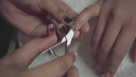 Manicurist-Removing-Fingernail-Cuticles-During-A-Cosmetic-Manicure