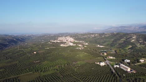 A-Cretan-village-panoramic-shot-would-typically-depict-a-wide,-expansive-view-of-a-traditional-Cretan-village