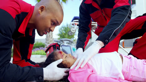 paramedics examining injured girl