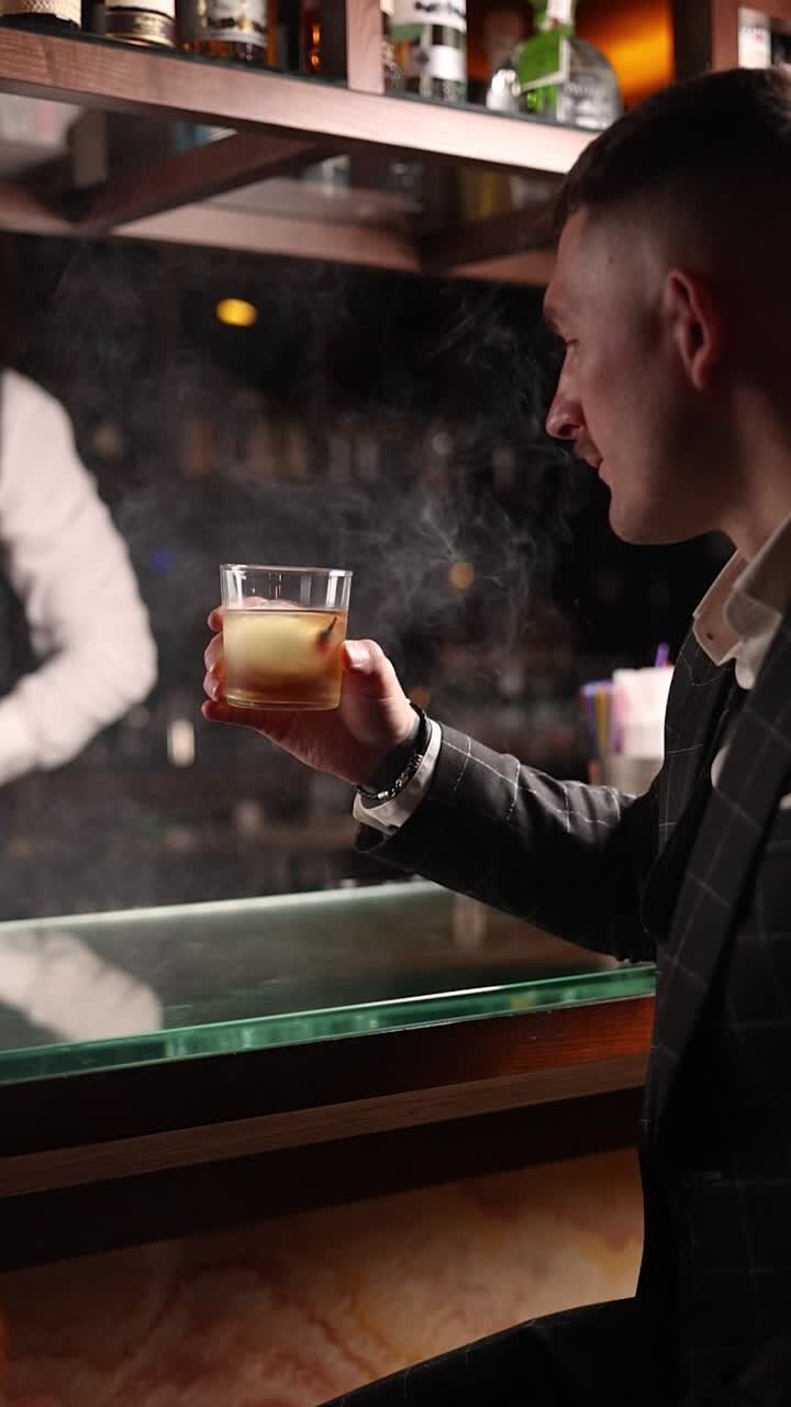 Man enjoying a cocktail at a stylish bar