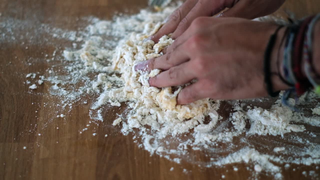 Artisan Breadmaking: Senior Chef's Hands Applying Flour on Dough - Slow-Mo Closeup