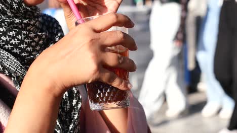 woman drinking iced coffee outside