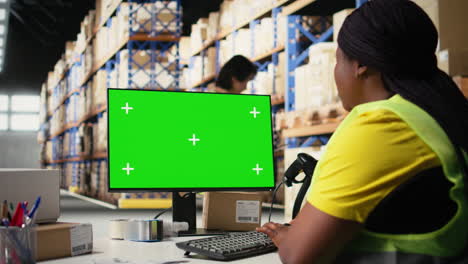 warehouse worker in a hi vis vest uses copy space display with shipping software