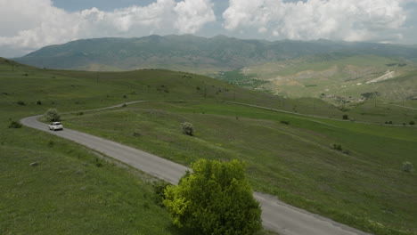 white suv vehicle driving on country road near aspindza in georgia