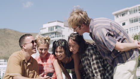 a group of young friends using a smartphone