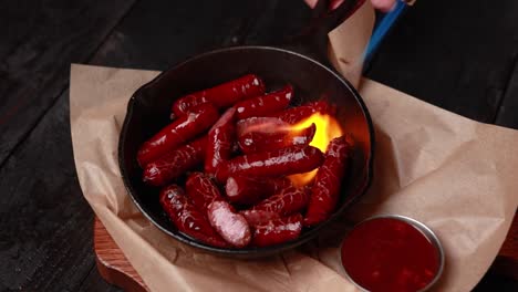 grilled mini sausages with torch and sauce