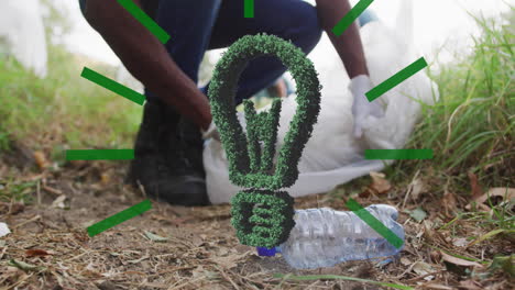 animación del icono de la bombilla sobre diversas personas limpiando en el bosque