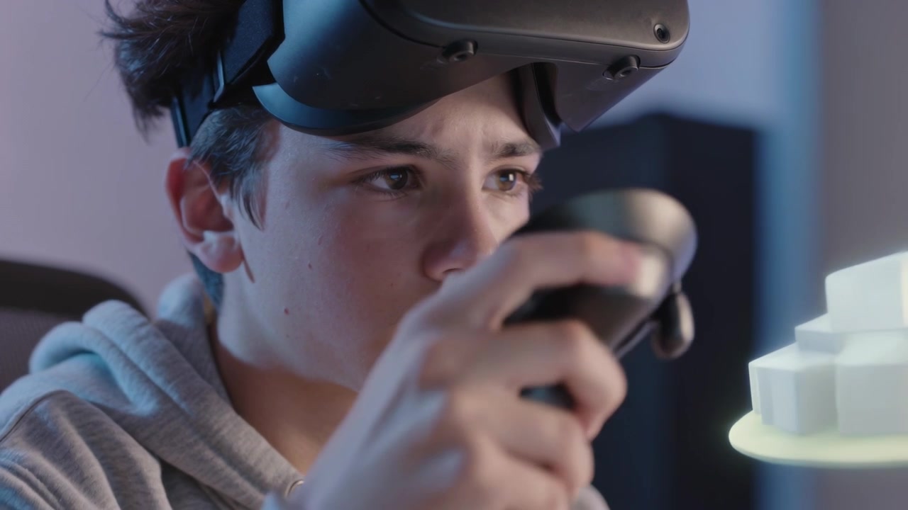 Steadying teen in hoodie with headset reacting to hologram, moving VR controller in gaming room