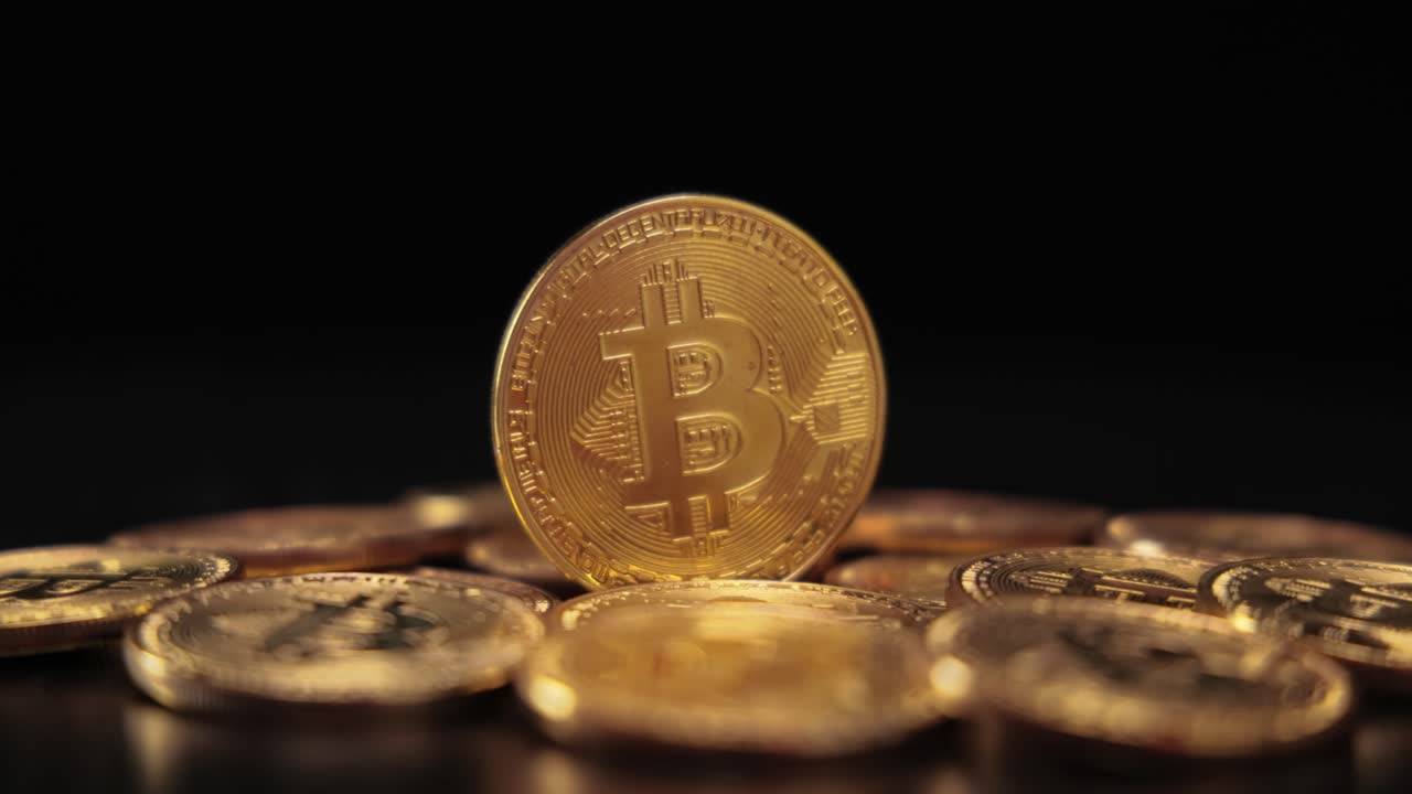 Gold Bit Coin BTC Cryptocurrency Coins on a black background. Bitcoin is a worldwide cryptocurrency and digital payment system called the first decentralized digital currency.