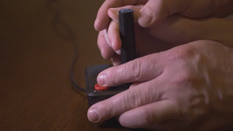 playing with old tv video game joystick. the child plays with the help of his father
