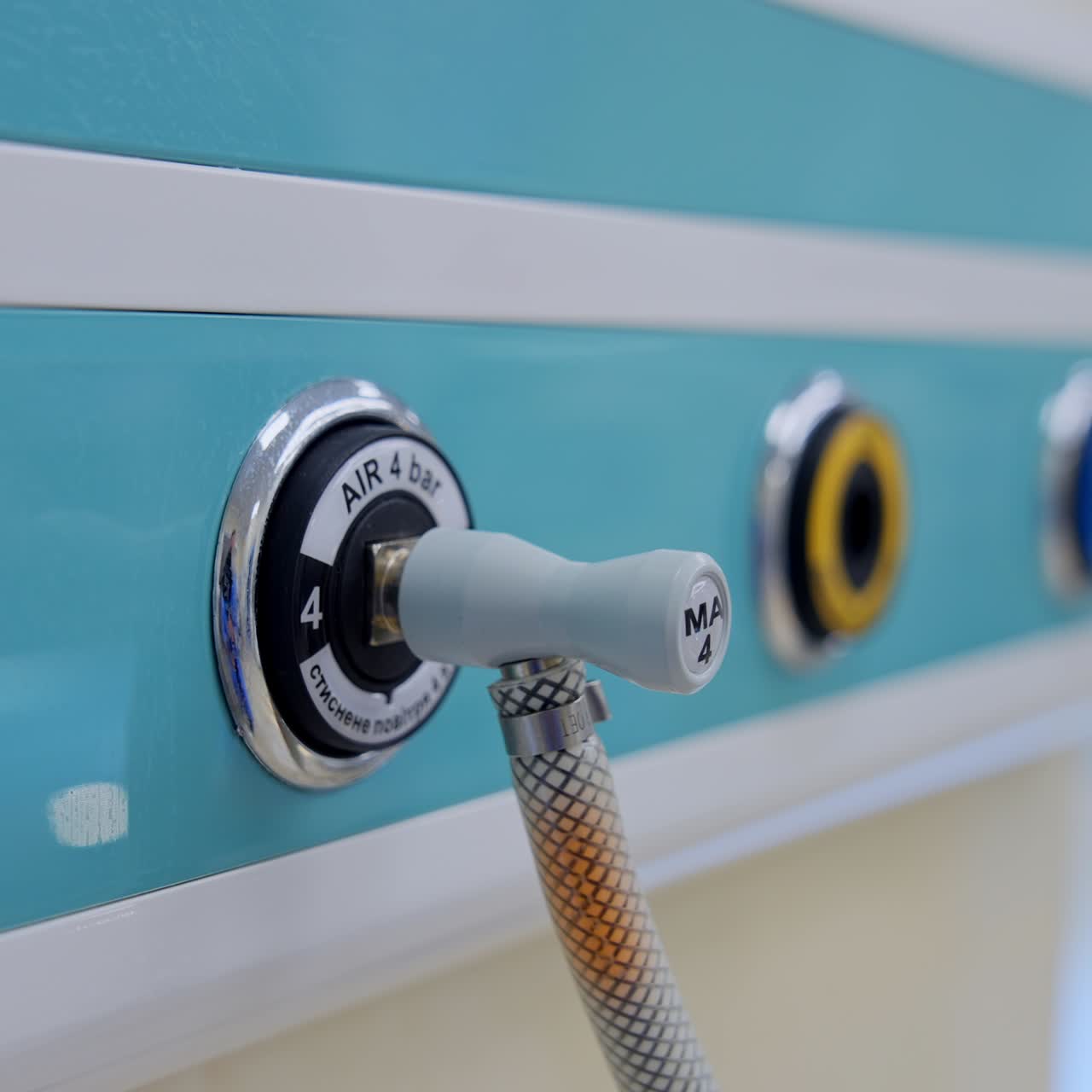 Air supplier connected to the apparatus through the tube. Slots in the panel on the wall of modern surgical theatre. Close up