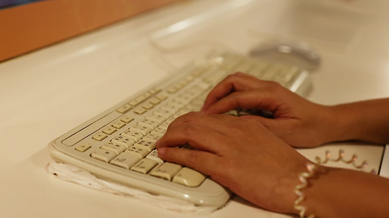 Hands typing on a keyboard in Hong Kong