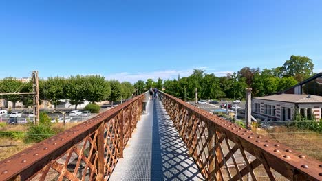 a bridge spans over train tracks in libourne