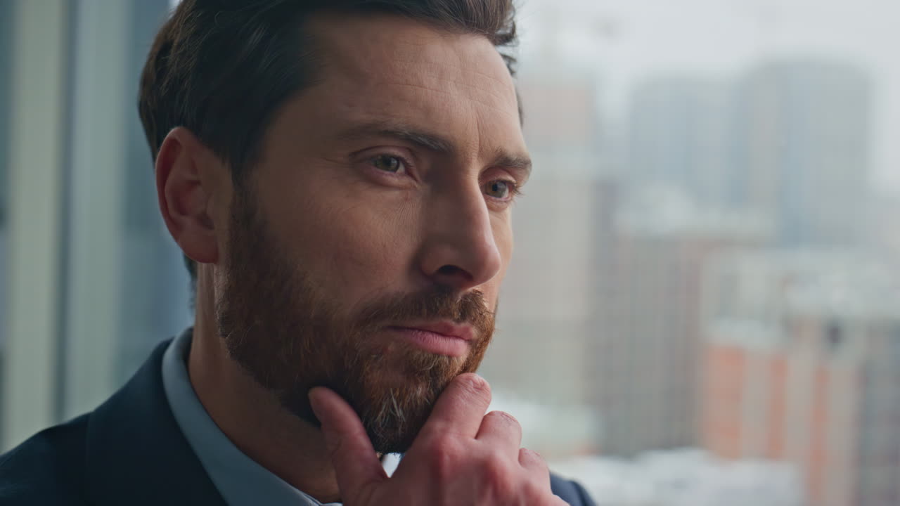 Pensive manager watching city in office panoramic window closeup. Man thinking