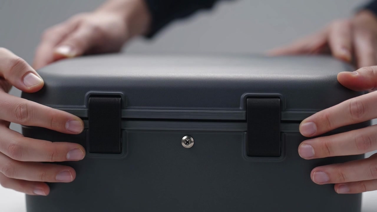 Person Closing a Grey Plastic Storage Container Lid
