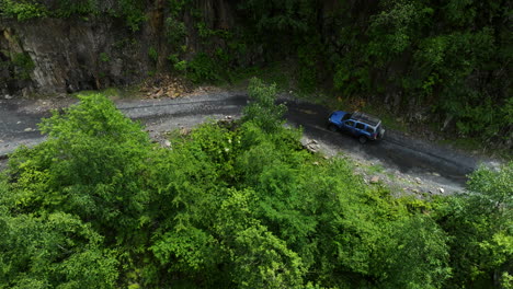 aerial view of off-road suv vehicle driving on dirt road of abano pass at summer in georgia