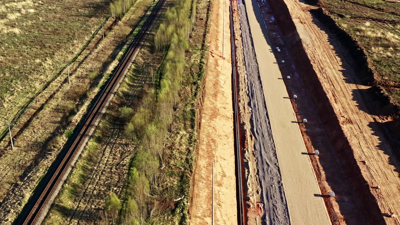 Drone view of new rail line construction site next to old single-track railway