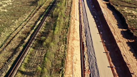 drone view of new rail line construction site next to old single-track railway