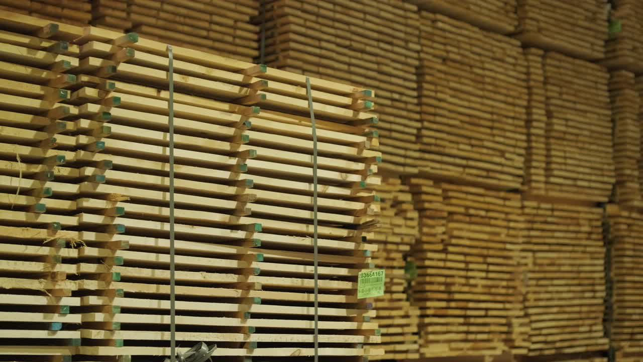 Large Stacks of Wooden Planks in a Warehouse