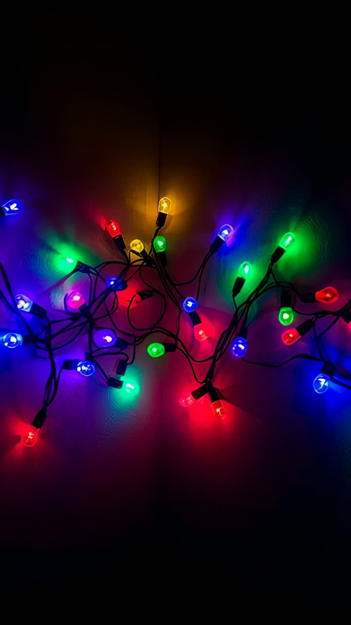 Vertical video: Starting clip, colorful string lights lit, pulsing on wall seam, showing dark wires