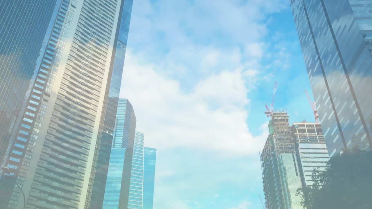 Skyscrapers with cranes and blue sky over cloud animation