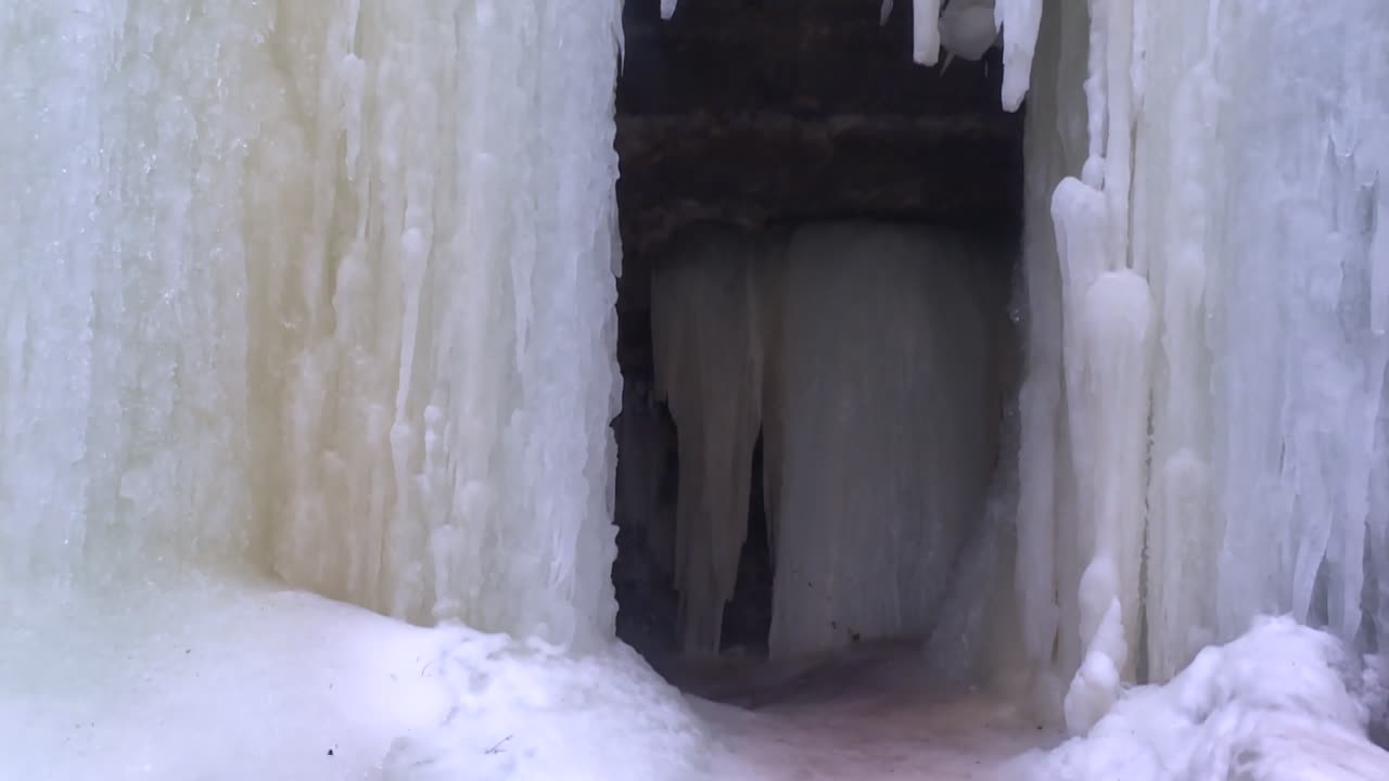 Entrance To The Eben Ice Caves With Ice Sheets Walls In Michigan, USA. - wide shot