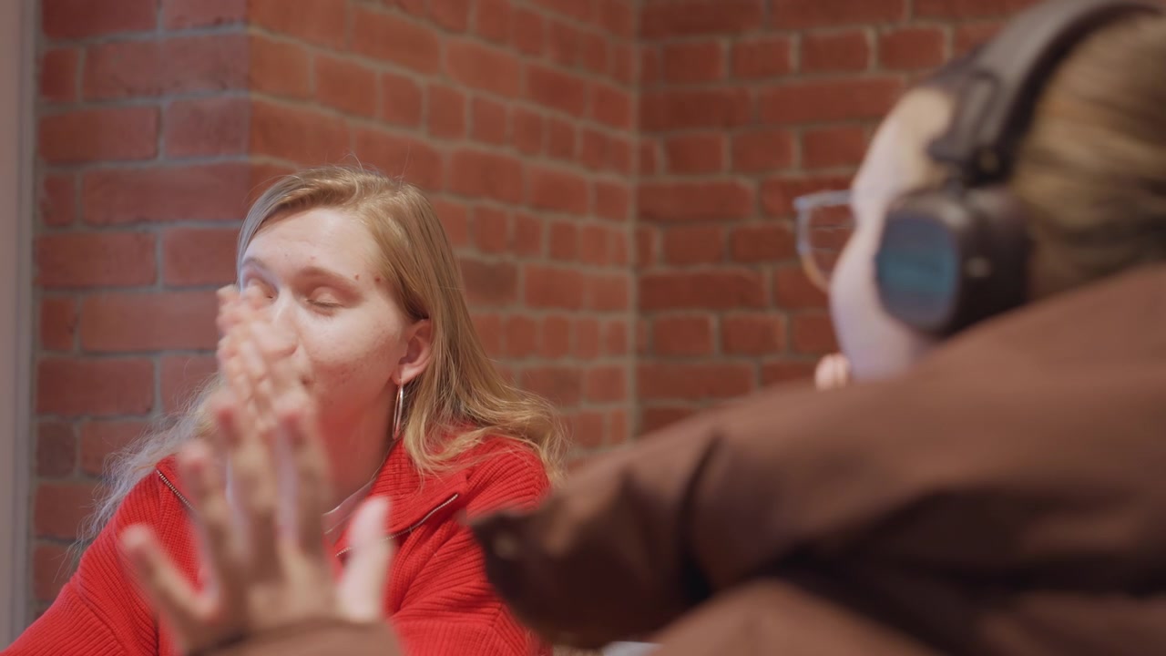 Young Woman Listens Attentively During a Casual Conversation