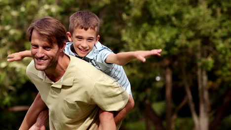 Father-giving-a-piggy-back-to-his-son