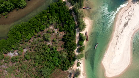 Top-down-vertical-aerial-drone-footage-flying-over-a-mangrove-river-an-a-beach-in-Cambodia