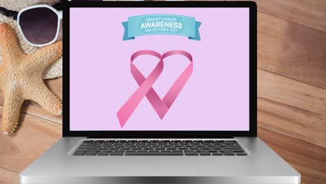 Animación-Del-Logotipo-De-La-Cinta-Rosa-Y-Texto-Sobre-El-Cáncer-De-Mama-En-La-Pantalla-Del-Portátil