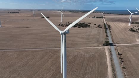 orbiting drone shot of spinning wind turbine