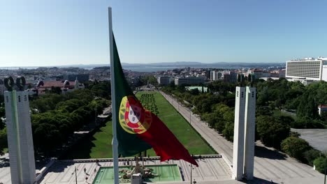 giant portugal flag winding in portuguese city capital