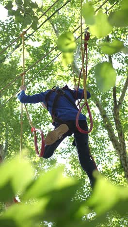 child ziplining through trees
