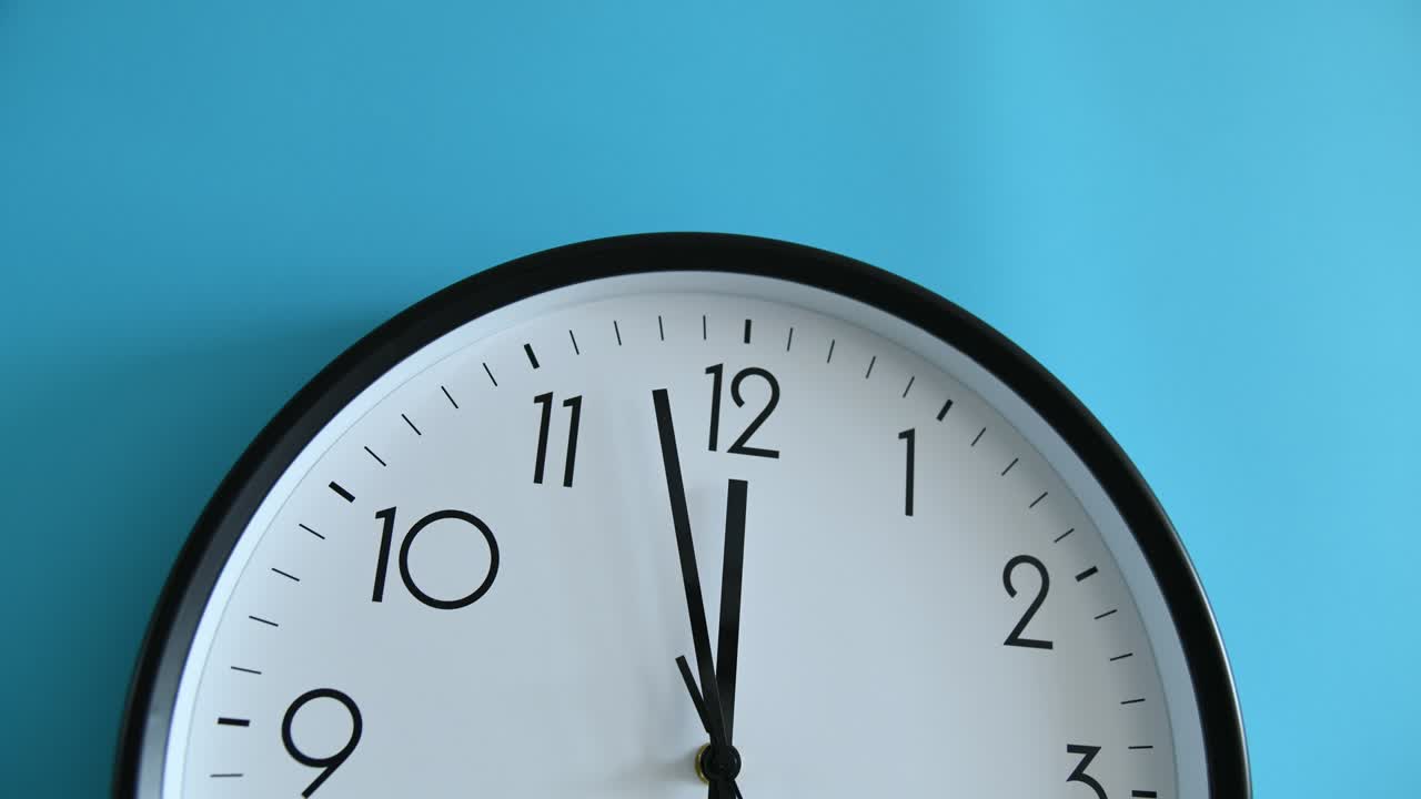 Time lapse of clock on blue wall