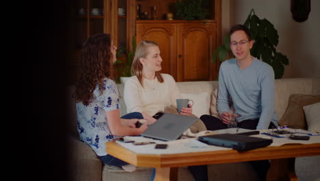 Friend-Woman-And-Man-Siting-On-Sofa-In-Living-Room-Smiling-And-Talking-3