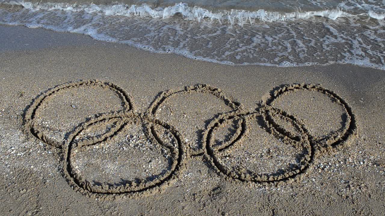 Five rings on sand, the beach. Symbol Olympic game on sand, the beach