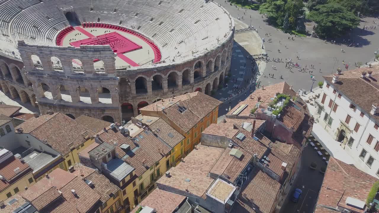 Aerial panoramic view of Arena di Verona, Italy. The drone hovers over the houses with tiled roofs. A view of the Arena and the city opens. 4k vieo.