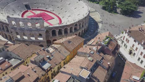 aerial panoramic view of arena di verona, italy. the drone hovers over the houses with tiled roofs. a view of the arena and the city opens. 4k vieo.