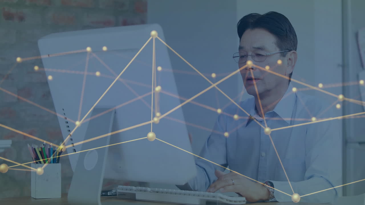 Working on computer, businessman analyzing network connections in office setting