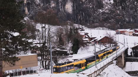 the wengenalpbahn leaving the waterfall village of lauterbrunnen for the valley town of wengen