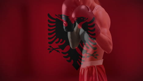 animation of flag of albania over caucasian female boxer